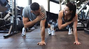 Image of man and woman doing Cardio Scotland to tone their arms. 